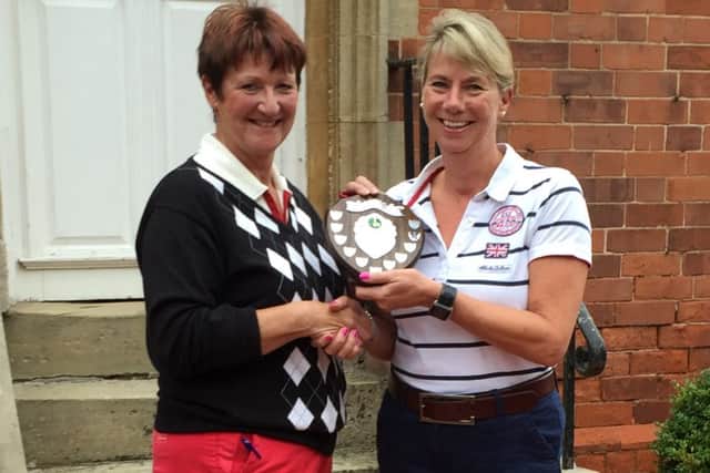 Ladies' vice-captain Andrea Smaggasgale (left) presents Cheryl Gilliatt with the Medal Winners' Shield EMN-160310-105105002