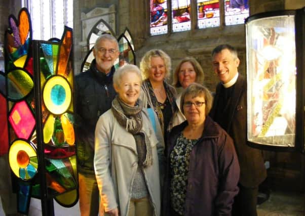 Members of the Glassumimass glass project unveil the finished lanterns with Rev Philip Johnson at St Deny's Church, Sleaford. Pictured with him are: David and Gillian Wing of Strawberry Glass of Spalding, Marion Sander of ArtsNK, Margot Charlton and Ann Hughes. EMN-161010-110236001