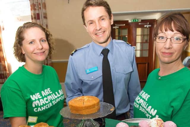 Personnel and staff at RAFC Cranwell held a charity cake stall today in aid of MacMillan Cancer Support in the station's all ranks club. As well as cake selling, the charities committee members also held a raffle draw and a "Guess the number of spots on the cake" fund raiser. RAFC Cranwell Commandant Air Commodore Peter Squires is pictured with MacMillan Cancer Support volunteers. Photo: Gordon Elias, RAFC Cranwell. EMN-160710-174417001