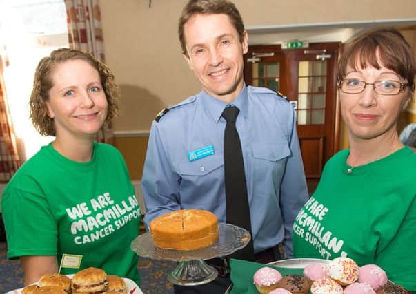 Personnel and staff at RAFC Cranwell held a charity cake stall today in aid of MacMillan Cancer Support in the station's all ranks club. As well as cake selling, the charities committee members also held a raffle draw and a "Guess the number of spots on the cake" fund raiser. RAFC Cranwell Commandant Air Commodore Peter Squires is pictured with MacMillan Cancer Support volunteers. Photo: Gordon Elias, RAFC Cranwell. EMN-160710-174417001