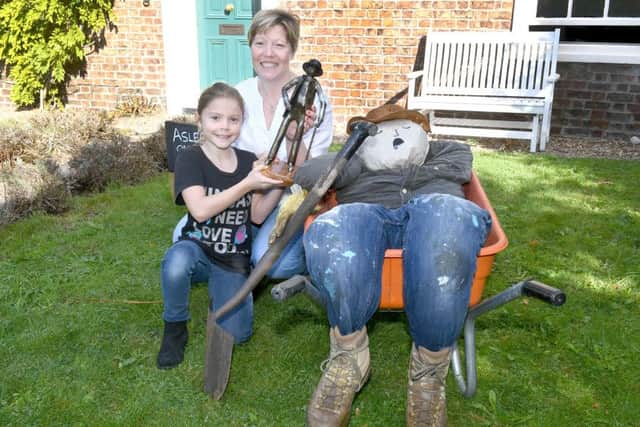 Billinghay Scarecrow Festival. Kelly Greig and Gabrielle Greig 9 with their winning scarecrow. EMN-160310-135710001