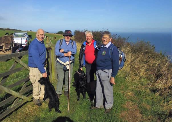Horncastle Lions Bob Wayne with Lucy, Andrew Tuxworth with Pup, Tony Clark and Peter Houldershaw in the bright autumn sunshine at Robin Hood's Bay EMN-160510-163506001