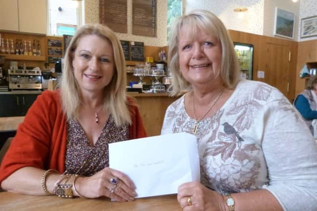 Deborah Barler (left) presenting the cheques to Jean Goddard. EMN-161210-163904001