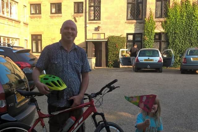 Colin Mackinder is waved off from Welbourn Manor on his bike ride by daughter Dottie, aged three. EMN-161013-174337001
