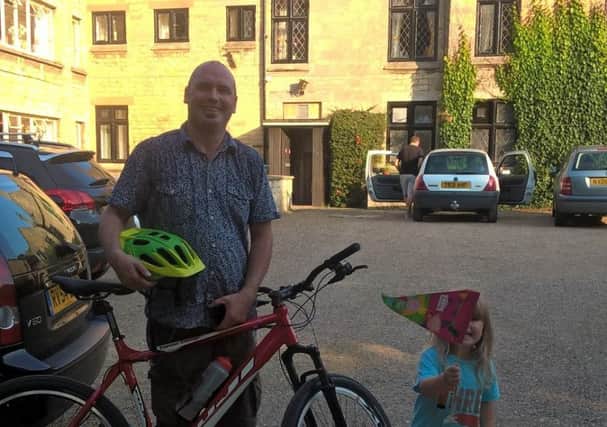 Colin Mackinder is waved off from Welbourn Manor on his bike ride by daughter Dottie, aged three. EMN-161013-174337001