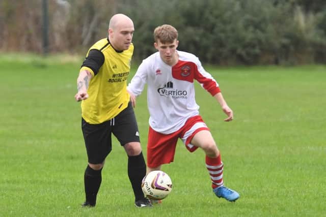 Wyberton Reserves' Michael Smith in action against Skegness Town Reserves' Charlie Arabin.