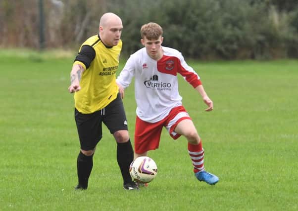 Wyberton Reserves' Michael Smith in action against Skegness Town Reserves' Charlie Arabin.