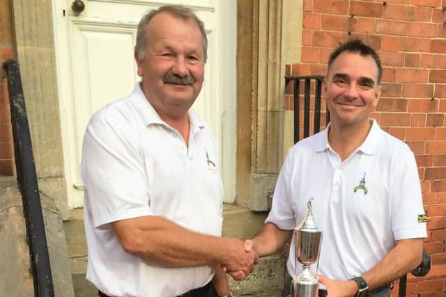 Seniors' captain Roger Culpin presents the Brooks Trophy to B Team skipper Nigel Fearn. EMN-161014-091146002