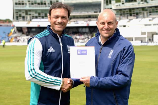 Adam Grist receives his Outstanding Contribution regional award from England batting coach mark Ramprakash during the Headingley Test match EMN-161014-115240002