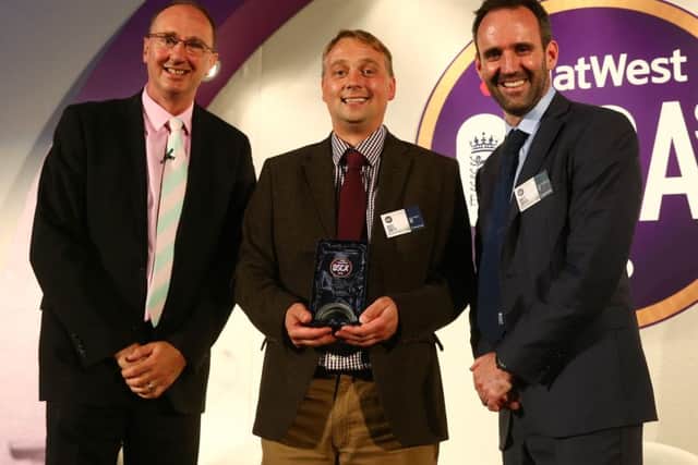 Greg Smith receives his national Coach of the Year Award from BBC cricket correspondent Jonathan Agnew (left) and the ECB's Director of Participation and Growth Matt Dwyer (right) EMN-161014-115229002
