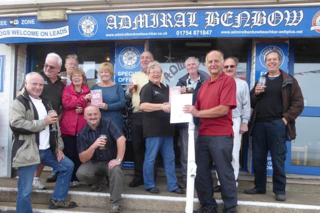 Staff at the Admiral Benbow raise a glass after being presented with their entry for CAMRA Good Beer Guide 2017
