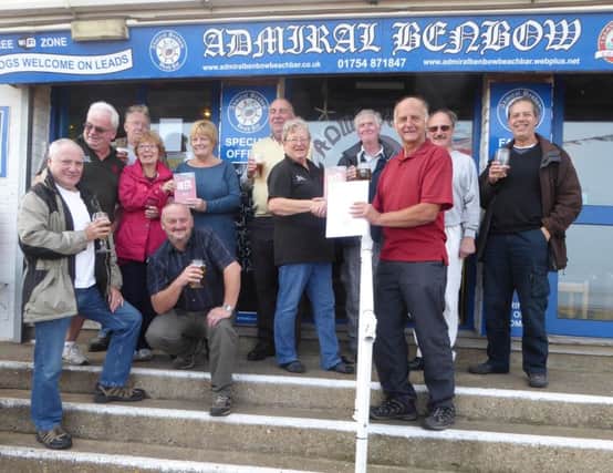 Staff at the Admiral Benbow raise a glass after being presented with their entry for CAMRA Good Beer Guide 2017