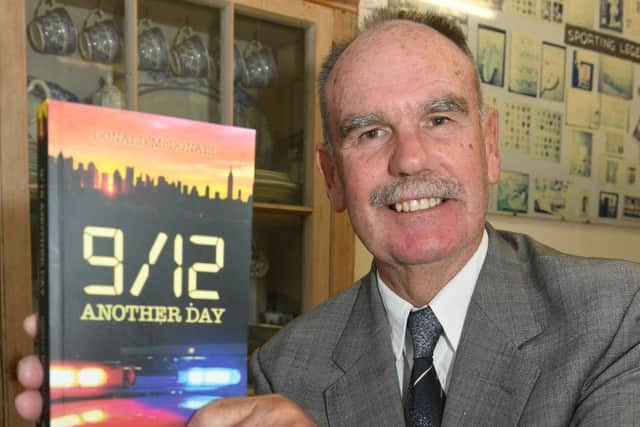 Author Donald McDonald with his new book, 9/12 EMN-161017-110752001
