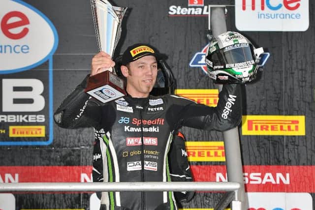 Peter Hickman toasts the Riders Cup on the Brands Hatch podium EMN-161017-122148002