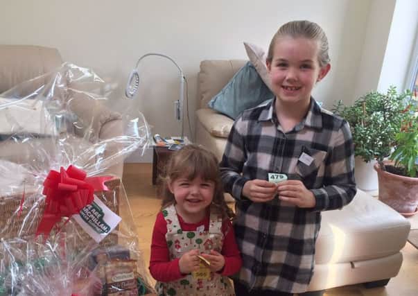 Pictured are youngsters Georgie and Pheobe drew the raffle on the day.