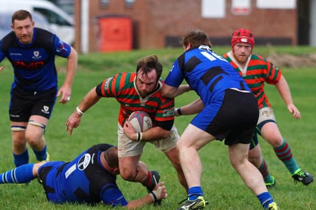 Chris Starling tries to break through the Glossop defence EMN-161017-153748002