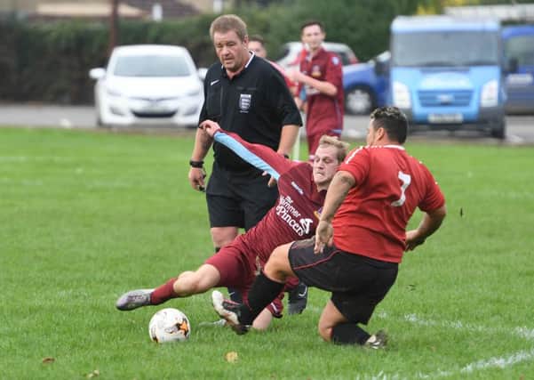 Kirton's Darren Eldin clashes with FC Hammers' Chris Brocklesby.