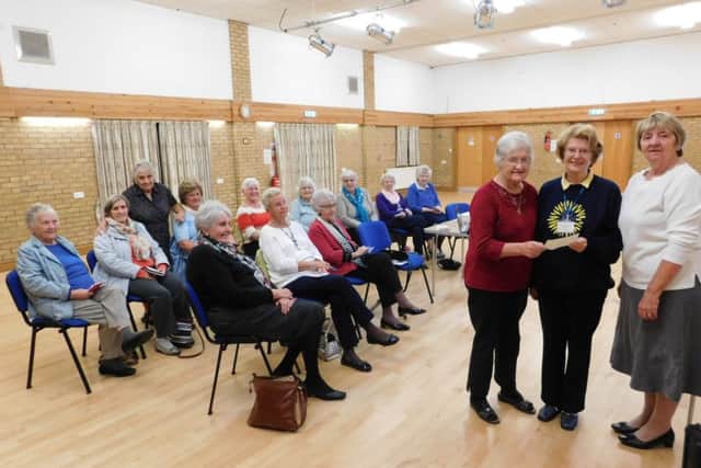 At Leasingham Ladies Club meeting Jean Stalham - treasurer (left) and Barbara Atherton - president (right) handed over a cheque for ?300 to Glenis Purdy (centre) of the St Barnabas Hospice Sleaford fundraising team after holding a fashion show with M & Co. EMN-161019-152832001