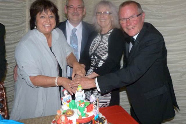 Cutting the CATS celebration cake are, from left, Sally Emery, Ralph Rodwell, Lynn Arthur and Mike Broster. EMN-161027-105700001