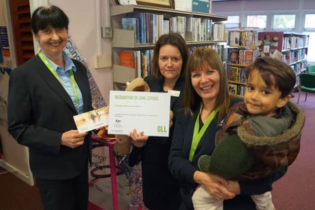 Pat Forester has been recognised for her 20 years service to the library service, pictured left, with fellow librarians Hazel Holden and Mel Fenwick and young reader Anthony Smith EMN-161025-120018001