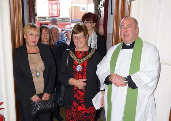 Brigg Town Mayor Ann Eardleybeing wlecomed to the church by father Owain Mitchell EMN-161027-165954001