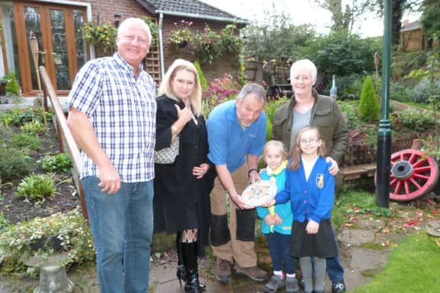 Winner of the Best Domestic Garden Cliff Rust (left) and Jill Rust (right) with grandchildren Daisy and Scarlet Elizabeth, CIB Deb Barker and Steve Penney. EMN-161027-174655001