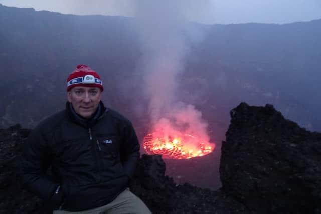 Andrew Pearce sits at the crater rim of the Virunga mountain range EMN-161027-155932001
