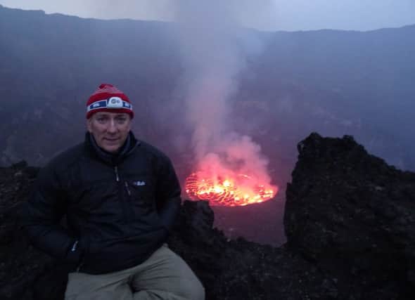 Andrew Pearce sits at the crater rim of the Virunga mountain range EMN-161027-155932001