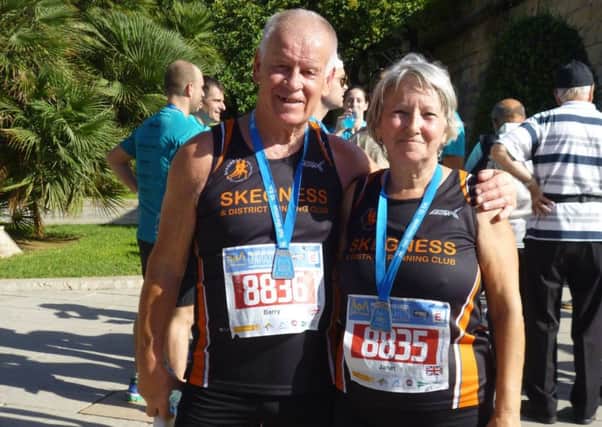 Barry and Janet Norton sporting their finishers' medals in Palma. Az3DPzRQlDpbto_9hkIN