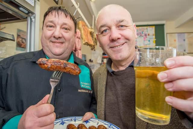 Mark Handson is pictured celebrating with Red Lion landlord Nick Wilkinson. Photo: John Aron.