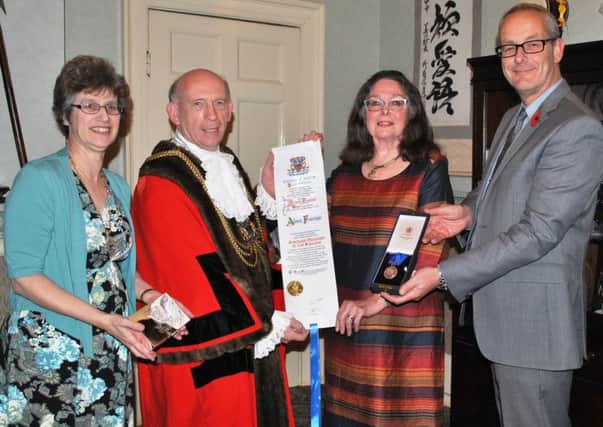 Alison, third from left, with her Honorary Freedom of the Borough scroll. From left, Mayoress Catharine Woodliffe, Mayor Coun Stephen Woodliffe and the councils Chief Executive Phil Drury.