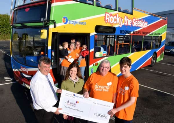 Stagecoach East Midlands making its Â£1,000 donation to Dreams Come True. Ian Naylor (operations manager at Skegness), Roanna Scott (marketing assistant), John and Sebastian (Dreams Come True family) standing in front of Rocky the Seasider.