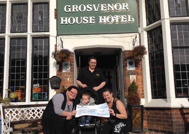 A cheque for ?1,200 for Harrison Thompson (centre) has been presented following a Zumbathon  at the Grosvenor House Hotel in Skegness. ANL-160411-111201001