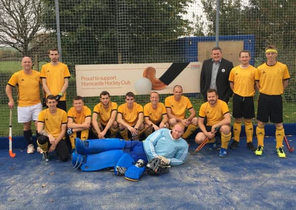 Horncastle Hockey Club men's first team with Luke McCluskey from Tesco who donated to the club's 'Pitch In' campaign for the resurfacing of the astroturf.