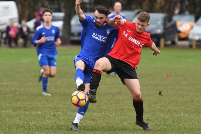Fishtoft's Reece Sullivan challenges Brandon Rylett of Coningsby Reserves.