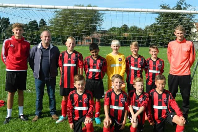 JFC Boston Under 12s are pictured receiving their kit from team sponsor Bycroft's of Boston.