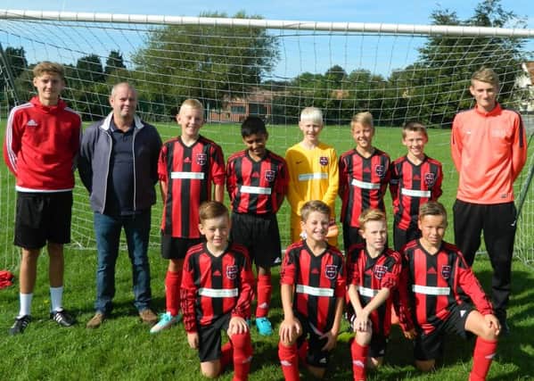 JFC Boston Under 12s are pictured receiving their kit from team sponsor Bycroft's of Boston.