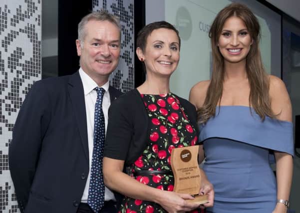 Kim Cinavas receives her award from Jake Kelly and Ferne McCann. EMN-160711-121722001