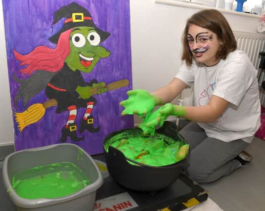 Sophie Healy, 13, attended the H.A.R.T fundraiser and bravely put her hands in the goo. EMN-160211-105437001
