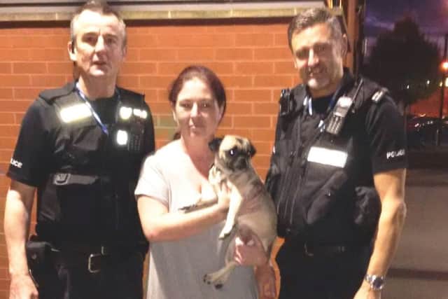 Vera Smyth collects Puggy from Pcs Martin Stannard and Martin Drew at Newark police station. EMN-160211-155259001