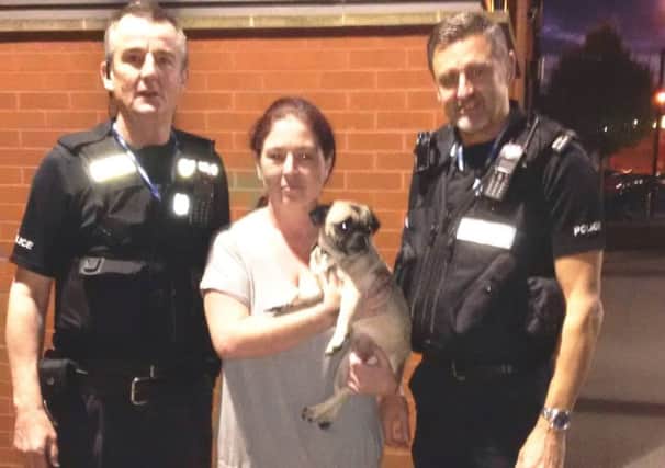 Vera Smyth collects Puggy from Pcs Martin Stannard and Martin Drew at Newark police station. EMN-160211-155259001