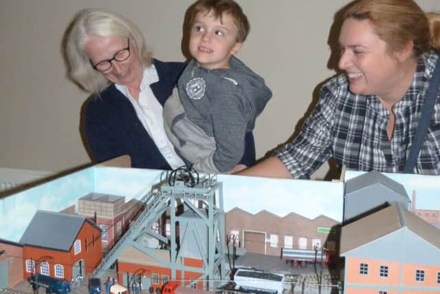 Angela Lewis (left) showing Benjamin Larder how to make The Harton Electric Railway 1948 move watched by Mum Emma Larder. (Lin) EMN-160711-104105001