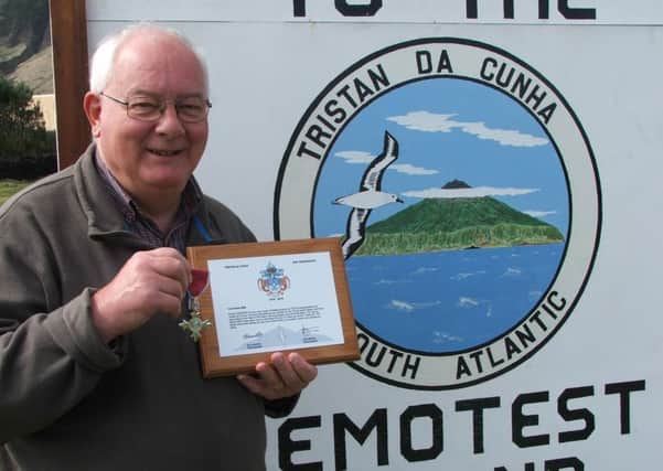 Former Standard reporter Chris Bates with the bicentennial plaque presented to him on Tristan du Cunha and his MBE.