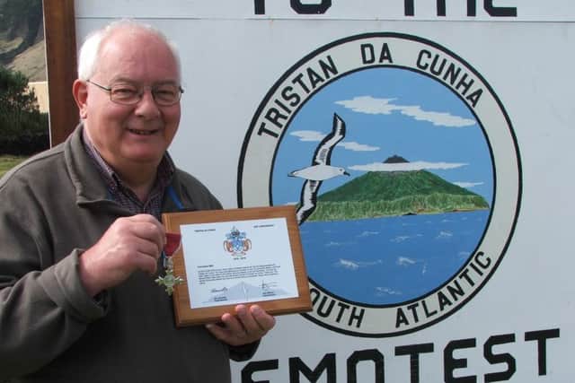 Former Standard reporter Chris Bates with the bicentennial plaque presented to him on Tristan du Cunha and his MBE.