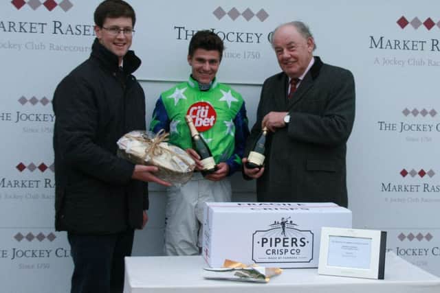 Market Rasen Racecourse chairman Collin Booth (right) presents the trophy to jockey Nick Schofield and trainer Harry Fry EMN-160711-093128002