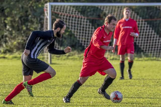 Coningsbys Jason Cooke makes a run for it during the derby game with Spilsby Town. Photo: Oscarpix Imaging.