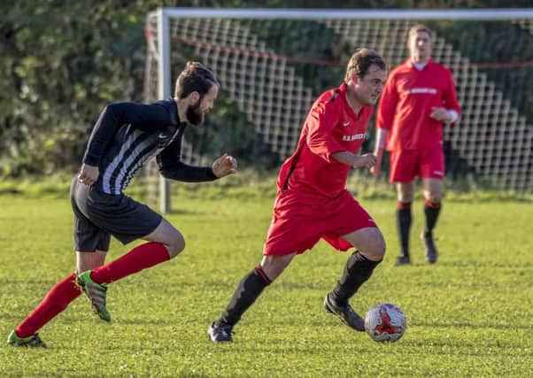 Coningsbys Jason Cooke makes a run for it during the derby game with Spilsby Town. Photo: Oscarpix Imaging.
