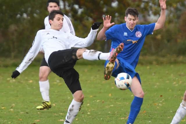 Boston International's Lytuynets Vladyslav and Wrangle's Joe Pitcher challenge for the ball.