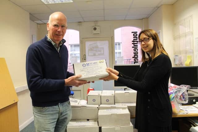 Reporter Chloe West hands over just some of the 400 shoe boxes donated by generous local residents from the Louth, Horncastle and Market Rasen areas.