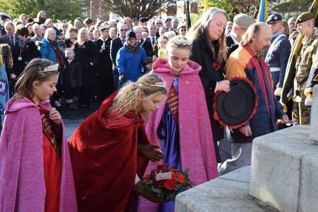 Carnival queen Ellie Mitchell, Princess Kimberley Ellis and Rosebud Alycia Dickinson, nine laying a wreath during the Remembrance Day parade in Skegness. Photo: Barry Robinson. ANL-161114-110628001